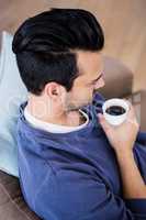 Man having a coffee on the couch