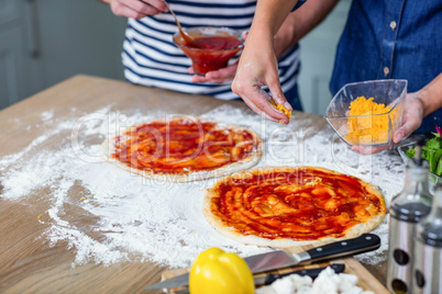 Smiling couple preparing pizza