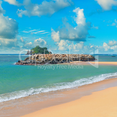 ocean, sandy beach and blue sky