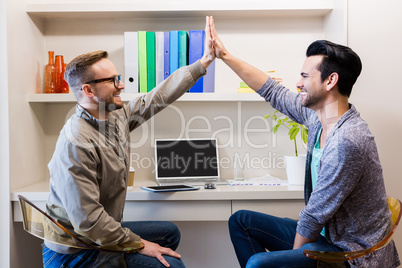 Happy gay couple doing high five