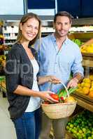Happy couple doing grocery shopping