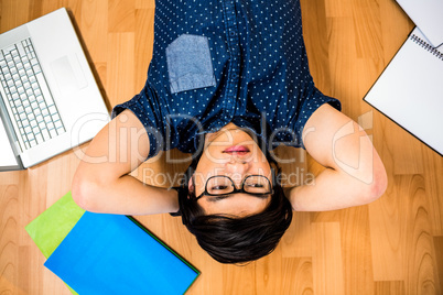 Hipster businessman lying on floor