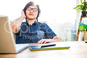 Smiling asian businessman listening to music