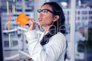 Asian woman removing sticky note