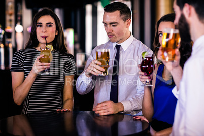 Friends drinking cocktails and beers