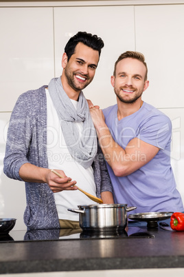 smiling gay couple preparing food