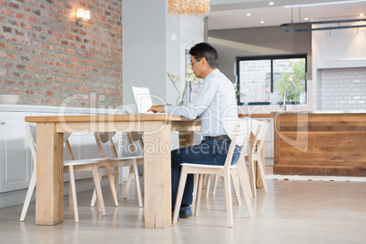 Serious man using laptop