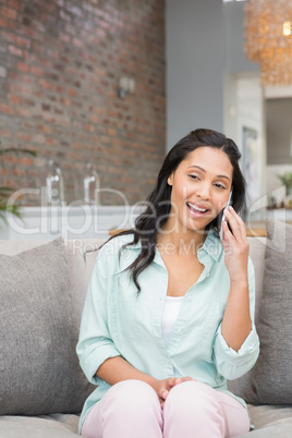 Smiling brunette on a phone call