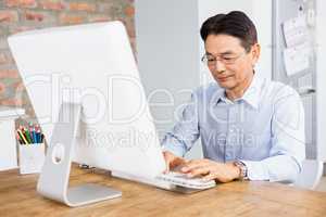 Smiling man using computer