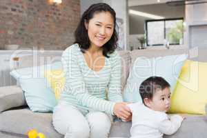 Happy mother with baby daughter in the living room