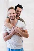 Smiling gay couple hugging
