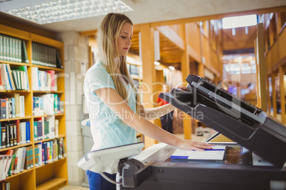 Smiling blonde student making a copy