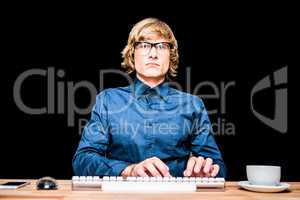 Focused hipster businessman using computer
