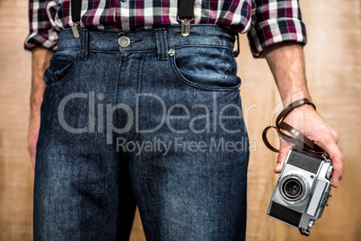 Hipster man holding digital camera