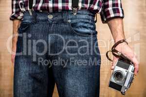 Hipster man holding digital camera