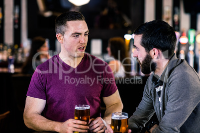 Friends talking and having a pint