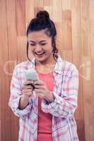 Happy Asian woman using smartphone