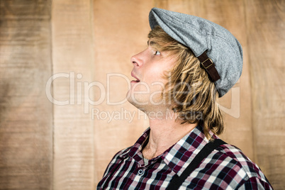 Side view of surprised blond hipster smiling