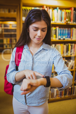 Brunette student using her smart watch