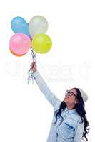 Asian woman holding colorful balloons