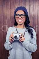 Asian woman holding digital camera