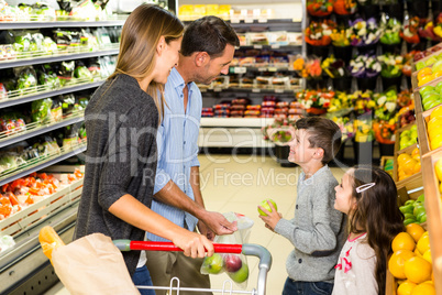 Cute family choosing groceries together