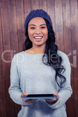 Asian woman holding tablet