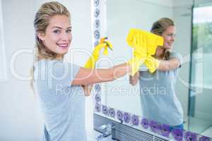 Woman cleaning the mirror