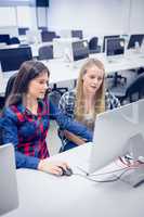 Smiling students using computer