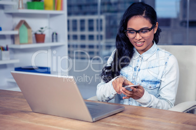 Smiling Asian woman using smartphone