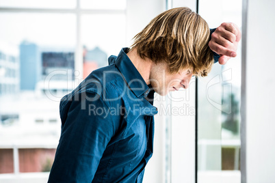 Hipster businessman looking out the window