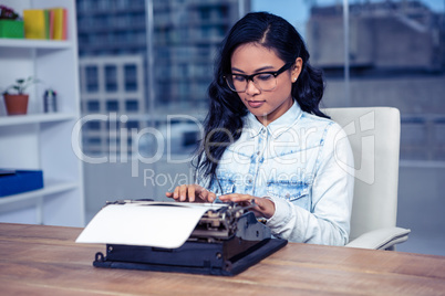 Asian woman typewriting