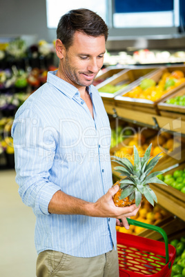 Man looking at a pineapple