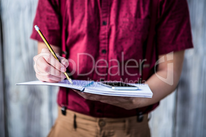 Hipster takes notes with his smartphone