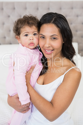 Portrait of happy brunette and her baby