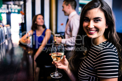 Portrait of woman having a drink with friends