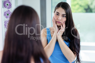 Sad brunette in bathroom