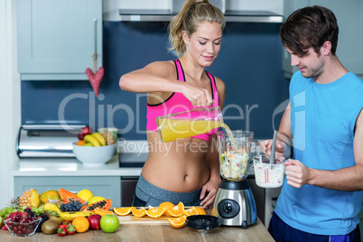 Healthy couple preparing a smoothie