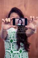 Smiling Asian woman taking selfie