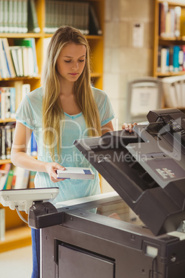 Smiling blonde student making a copy