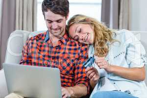 Couple paying with credit card on laptop