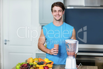 Healthy man preparing a smoothie