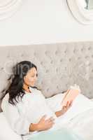 Pregnant brunette reading a book