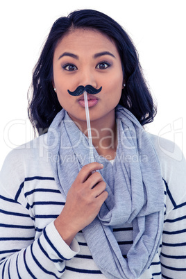 Pretty Asian woman with fake mustache posing for camera