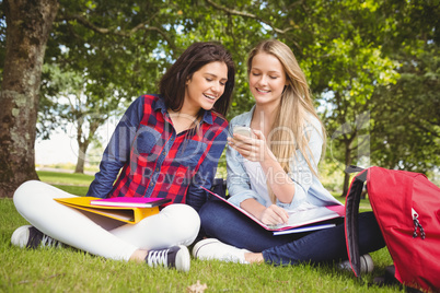 Smiling students using smartphone