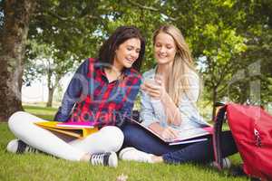 Smiling students using smartphone