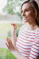 Happy female student looking through the window