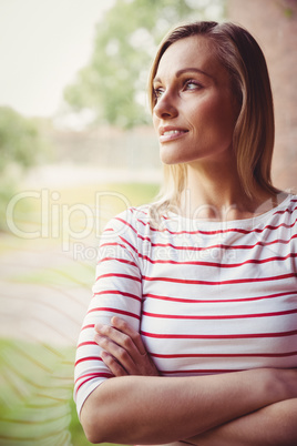 Thoughtful female student looking through the window
