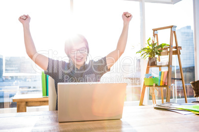 Cheerful asian businessman using laptop