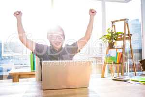 Cheerful asian businessman using laptop